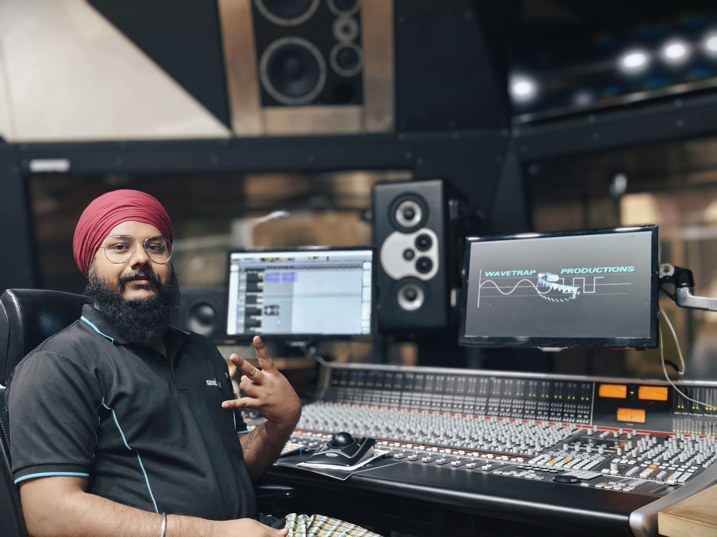 Engineer at the console, Wavetrap Productions mark on screen